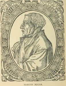 Woodcut of Martin Bucer in profile, facing left, bareheaded with short curly hair and a robe, inside an ornate oval frame.